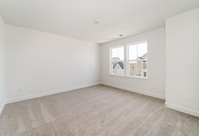 empty room featuring light carpet