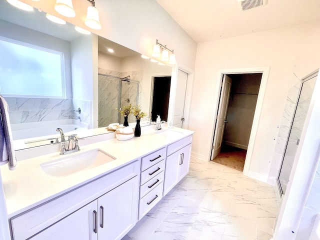 bathroom with vanity and separate shower and tub