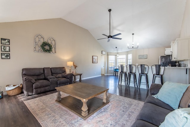 living room featuring dark hardwood / wood-style flooring, ceiling fan with notable chandelier, and lofted ceiling