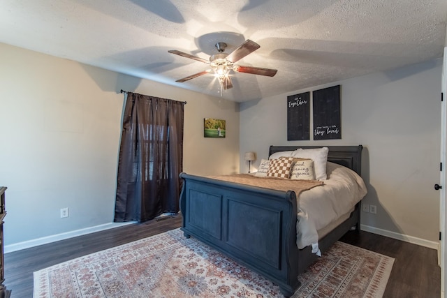 bedroom with ceiling fan, dark hardwood / wood-style flooring, and a textured ceiling