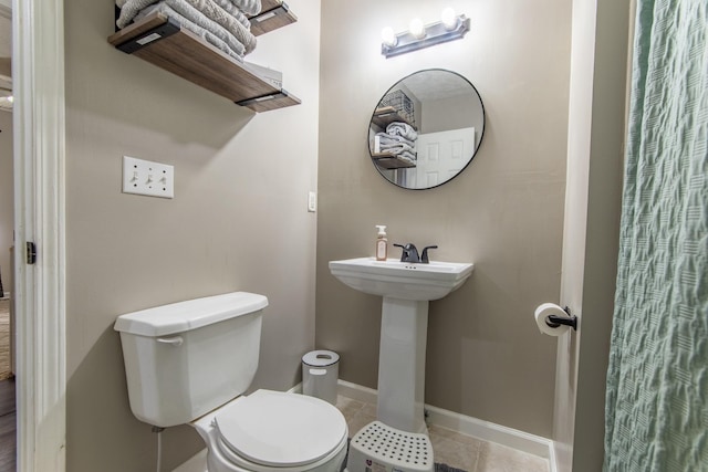 bathroom featuring tile patterned floors, toilet, and sink