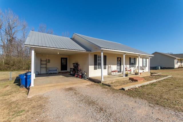 ranch-style home with covered porch and a carport