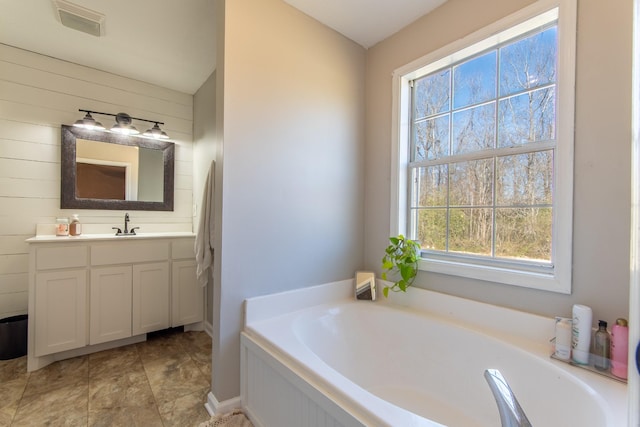 bathroom featuring a bathing tub and vanity