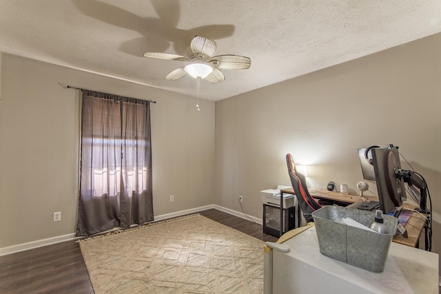 office featuring ceiling fan, dark wood-type flooring, and a textured ceiling