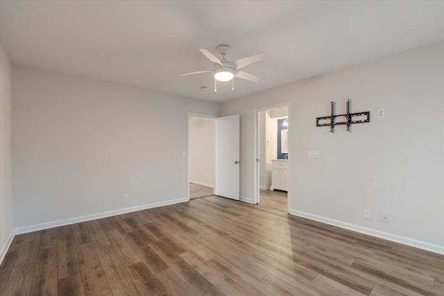 empty room featuring hardwood / wood-style floors and ceiling fan