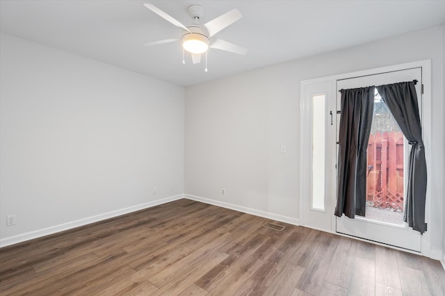 unfurnished room with ceiling fan and wood-type flooring