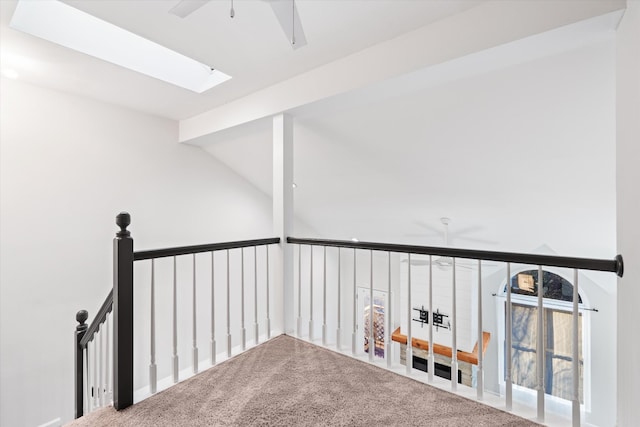 interior space with carpet floors and lofted ceiling with skylight