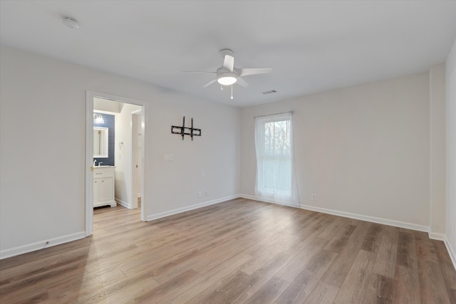 spare room with ceiling fan and light hardwood / wood-style floors