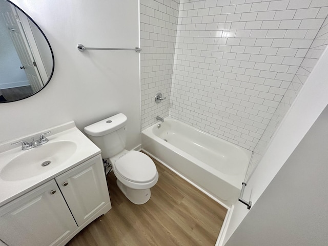 full bathroom with vanity, wood-type flooring, tiled shower / bath combo, and toilet