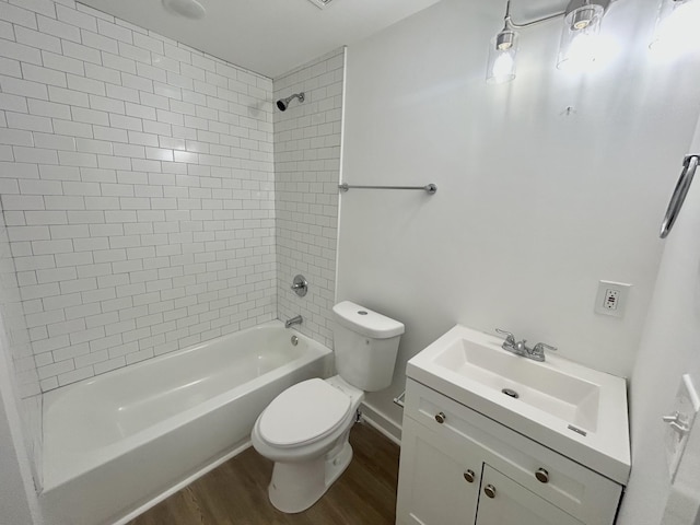 full bathroom featuring tiled shower / bath, toilet, vanity, and hardwood / wood-style flooring