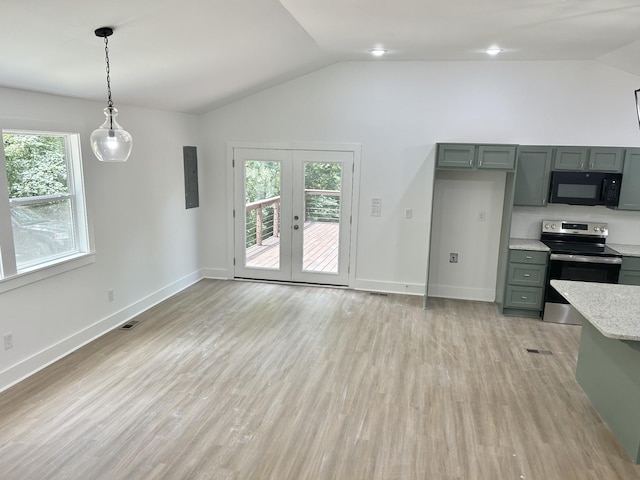 kitchen featuring stainless steel electric stove, decorative light fixtures, a healthy amount of sunlight, and vaulted ceiling