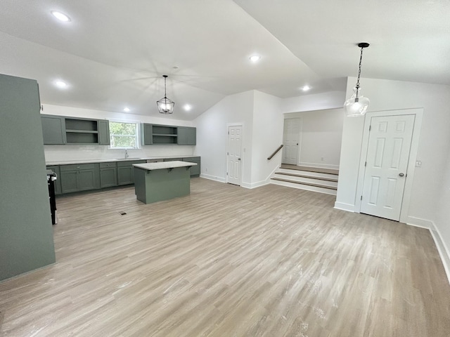 kitchen with a kitchen island, pendant lighting, and light hardwood / wood-style floors