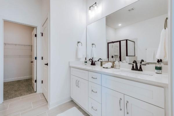 bathroom with vanity and a shower with shower door