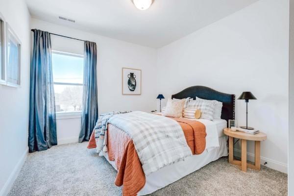 bedroom with light colored carpet