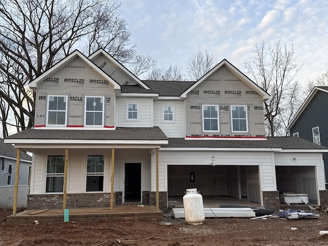 view of front facade featuring covered porch and a garage