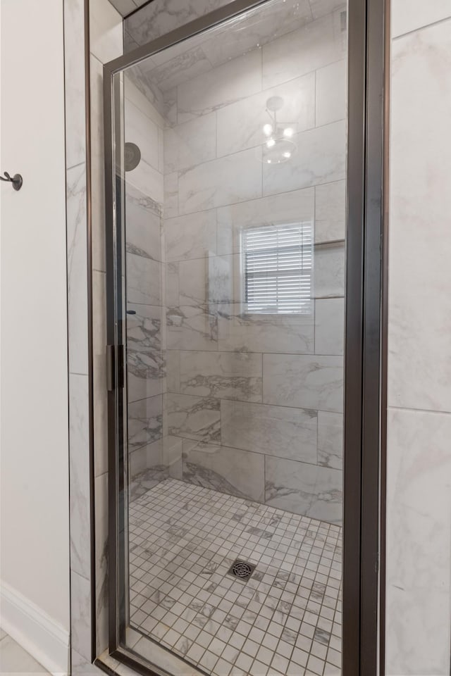 bathroom featuring a shower with shower door