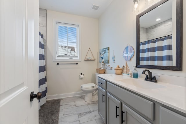 bathroom featuring walk in shower, vanity, and toilet