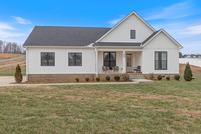 modern farmhouse style home with a porch and a front yard