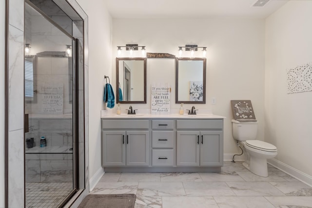 bathroom featuring vanity, toilet, and a shower with shower door