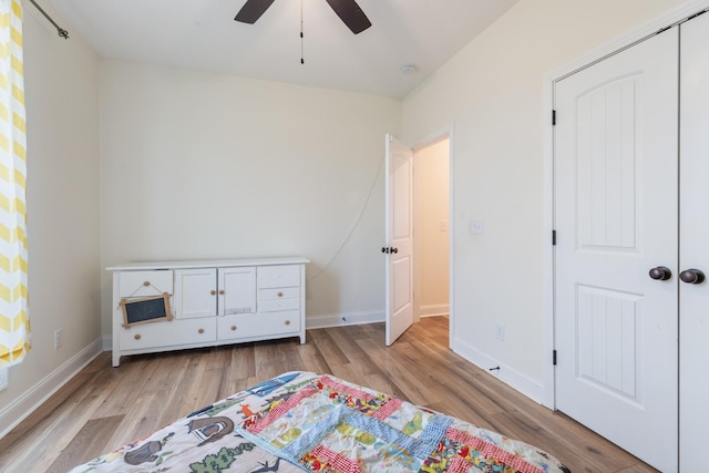 bedroom with a closet, light hardwood / wood-style flooring, and ceiling fan