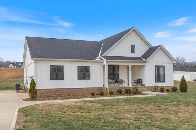 modern farmhouse featuring central AC unit, a porch, and a front yard