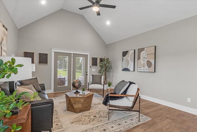 sitting room featuring light hardwood / wood-style floors, high vaulted ceiling, and ceiling fan