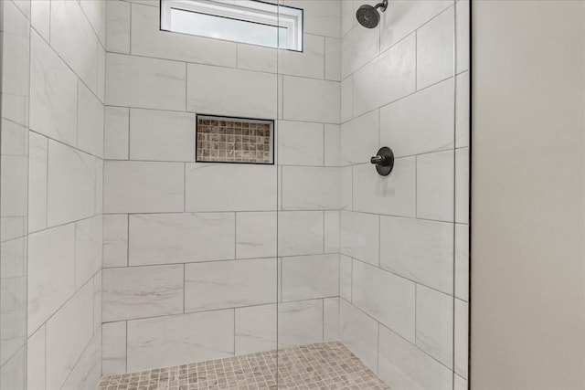 bathroom with a tile shower