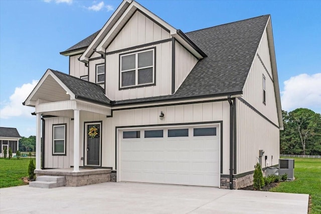 view of front facade with a garage and central AC unit