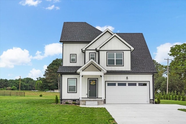 view of front of property featuring a garage and a front lawn