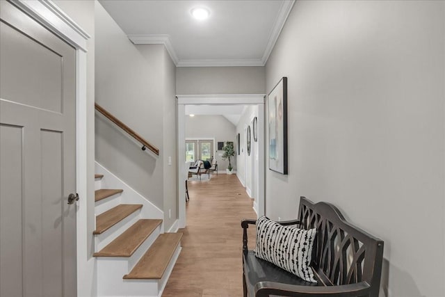 foyer with light wood-type flooring and ornamental molding