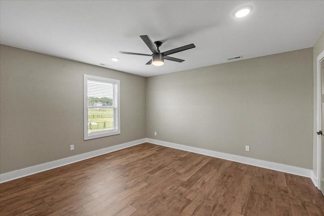 empty room featuring hardwood / wood-style flooring and ceiling fan