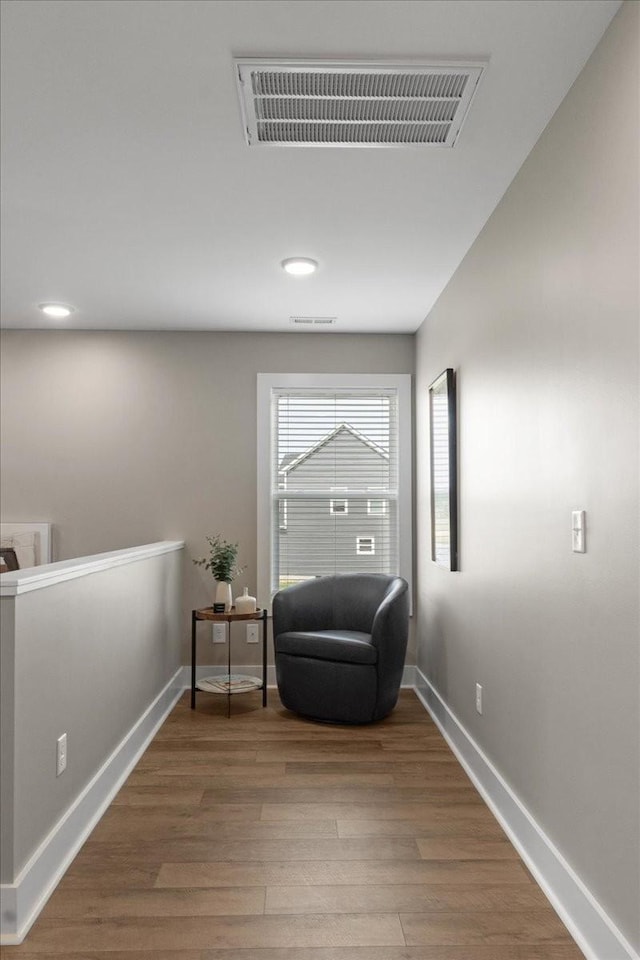 sitting room with wood-type flooring