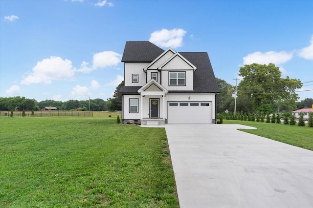 view of front of property with a garage and a front yard