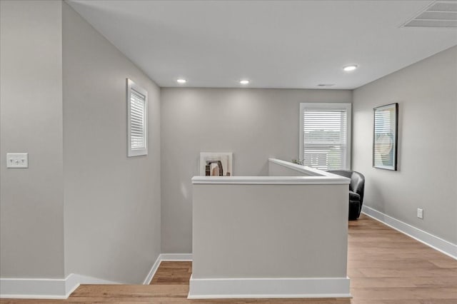 hallway with light hardwood / wood-style flooring