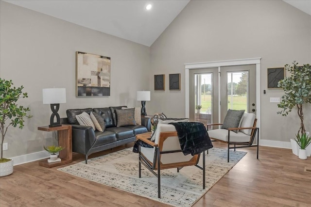 living room featuring hardwood / wood-style floors and high vaulted ceiling