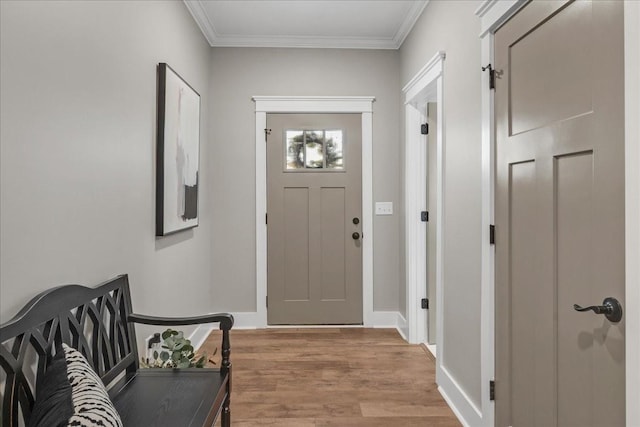 doorway featuring light wood-type flooring and ornamental molding