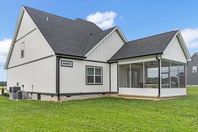 back of property with a sunroom and a lawn