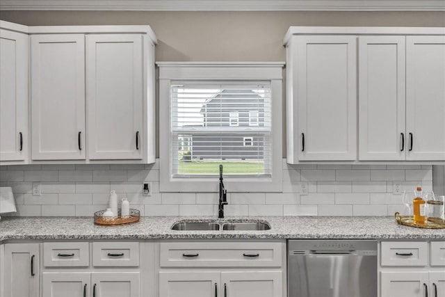 kitchen featuring light stone countertops, dishwasher, sink, decorative backsplash, and white cabinets