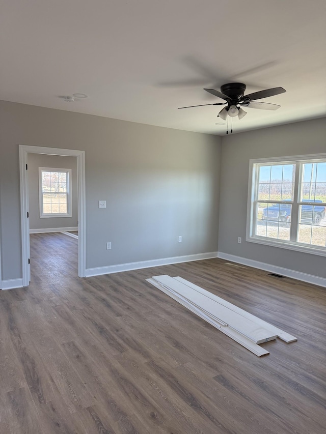 unfurnished room with hardwood / wood-style floors and ceiling fan