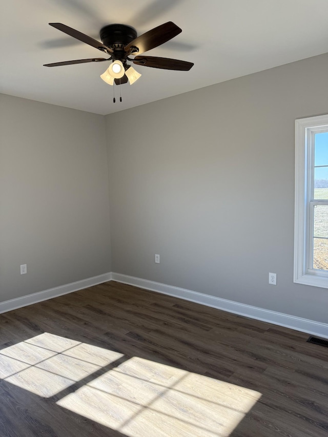 spare room with hardwood / wood-style flooring and ceiling fan