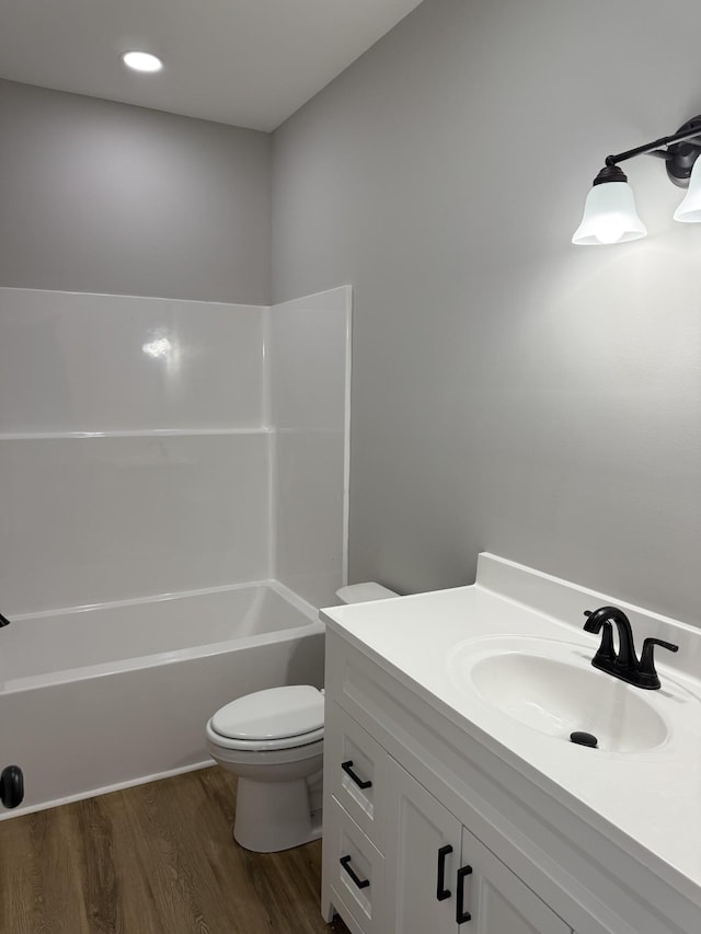 full bathroom with vanity, wood-type flooring, bathtub / shower combination, and toilet