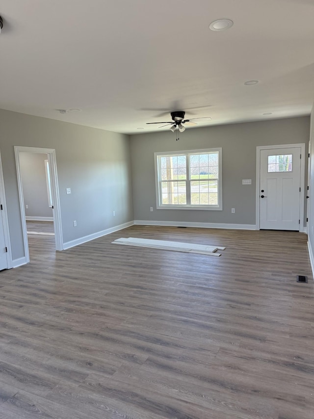 unfurnished living room featuring light wood-type flooring and ceiling fan