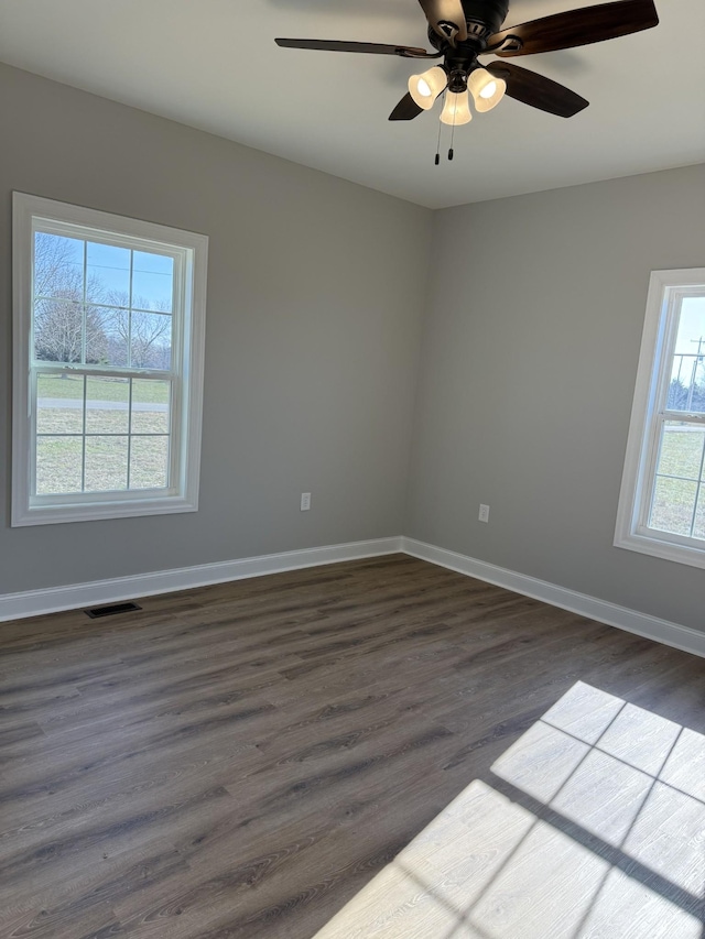 spare room featuring ceiling fan and dark hardwood / wood-style flooring