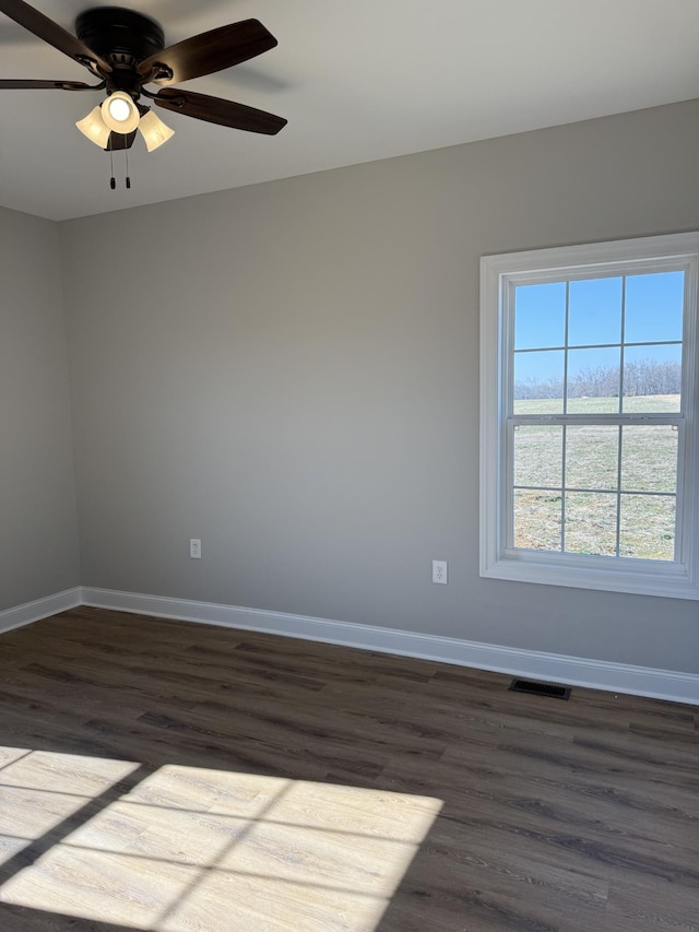 unfurnished room featuring dark hardwood / wood-style floors and ceiling fan