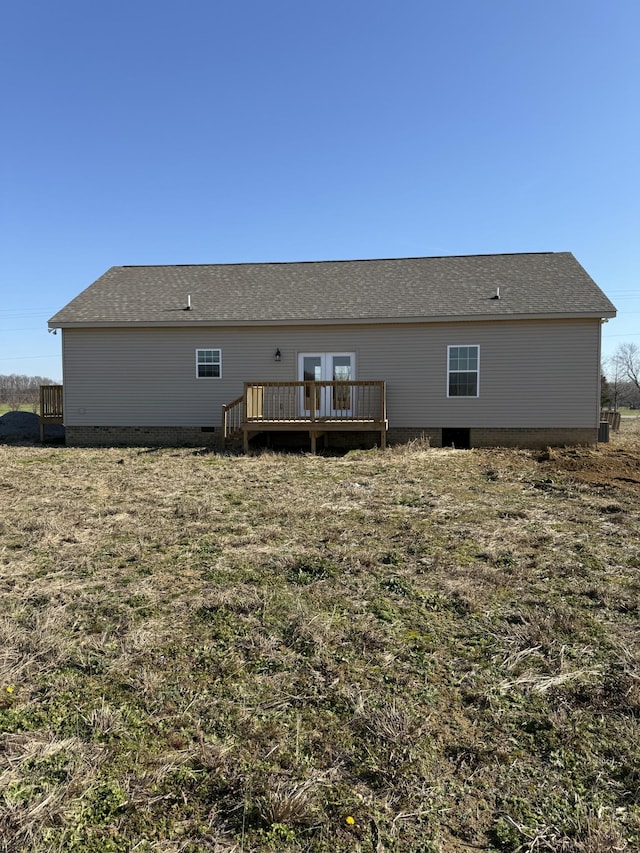 back of house with a deck and a lawn