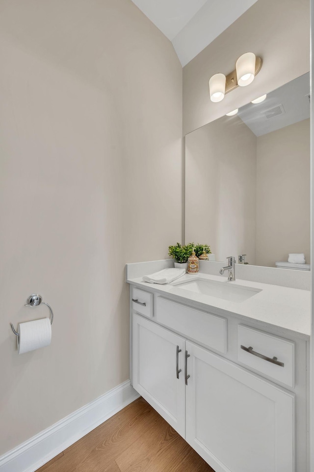 bathroom with hardwood / wood-style floors and vanity