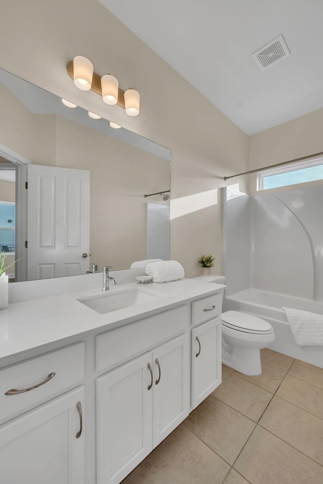 full bathroom featuring washtub / shower combination, tile patterned flooring, vanity, and toilet