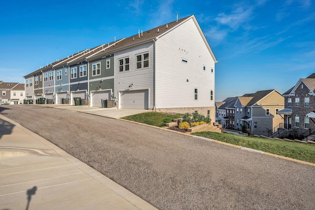 exterior space with central AC and a garage