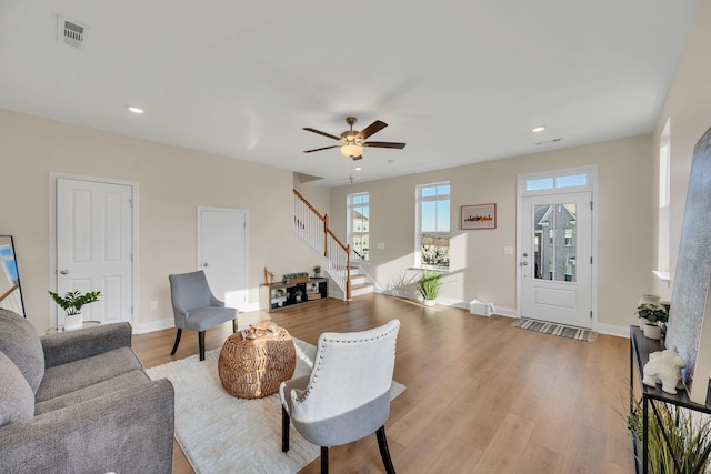 living room featuring ceiling fan and light hardwood / wood-style floors