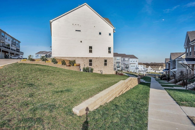 view of home's exterior with a lawn